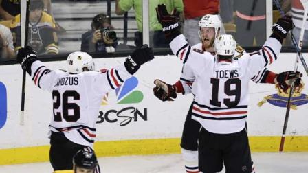 Chicago Blackhawks left wing Bryan Bickell, center, celebrates his goal with Chicago Blackhawks center Jonathan Toews (19) and Chicago Blackhawks center Michal Handzus (26), of Slovakia, during the third period in Game 6.