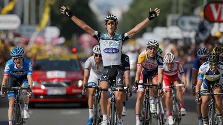 Matteo Trentin of Italy celebrates crossing the finish line ahead of Michael Albasini of Switzerland, far right, and Andrew Talansky of the U.S., far left, to win the fourteenth stage of the Tour de France cycling race over 191 kilometers (119.4 miles) with start in in Saint-Pourcain-sur-Sioule and finish in Lyon, central France, Saturday July 13 2013. (AP Photo/Laurent Rebours)