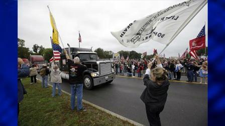 A crowd converged on the World War II Memorial on the National Mall, pushing through barriers Sunday morning to protest the memorials closing under the government shutdown