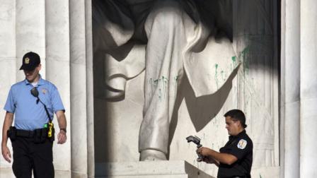U.S. Park Police close off the Lincoln Memorial to visitors after someone splattered green paint on the statue and the floor area, in Washington, Friday, July 26, 2013. Police say the apparent vandalism was discovered early Friday morning. No words, letters or symbols were visible in the paint.