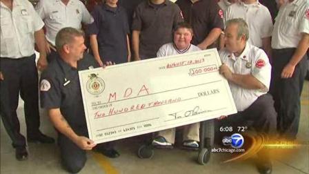 Chicago firefighters presented the Muscular Dystrophy Associations goodwill ambassador Bryan Foster with a check for $200,000 dollars from their recent Fill the Boot campaign.