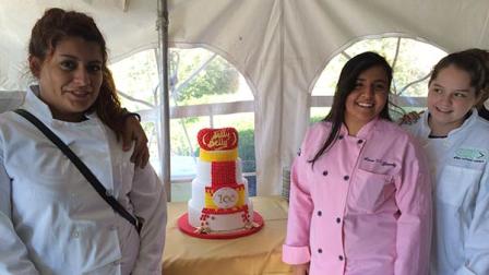 Current After School Matters students with Jelly Belly in North Chicago with the 100th Anniversary Cake, made by ASM alumni Adam Ornelas.