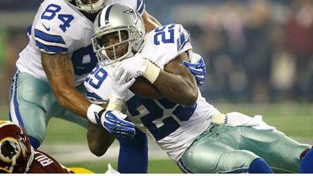 DeMarco Murray (29) dives for extra yardage as he is helped by teammate James Hanna (84) during the first half of an NFL football game against the Washington Redskins in Arlington, Texas.