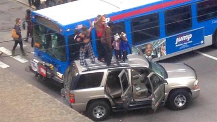 Three people were arrested Thursday afternoon as they danced on the top of their SUV stopped in the middle of LaSalle Street in downtown Chicago.