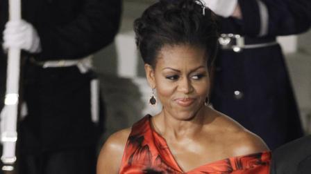 This Jan. 19, 2011 file photo shows first lady Michelle Obama at the North Portico of the White House in Washington as they the arrival of Chinas President Hu Jintao for the State Dinner. Michelle Obama is wearing a fiery red gown designed by Alexander McQueen. Obama has proven her fashion savvy time and time again since she was introduced to the country as first lady on Inauguration Day 2009. In the past four years she has adeptly walked the line between directional fashionista and everywoman. (AP Photo/Charles Dharapak, file)