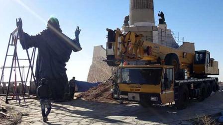This Oct. 14, 2013 photo provided by the St. Pauls and St. Georges Foundation shows workers preparing to install a statue of Jesus on Mount Sednaya, Syria. In the midst of a civil war rife with sectarianism, a 12.3-meter (40-foot) tall, bronze statue of Jesus has gone up on a Syrian mountain, apparently under cover of a truce among three factions - Syrian forces, rebels and gunmen in the Christian town of Sednaya. (AP Photo/Samir El-Gadban, St. Pauls and St. Georges Foundation)