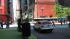 A car stops at the blue crosswalk to let...