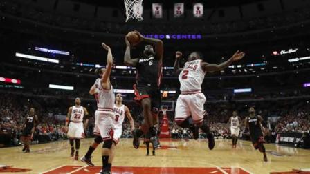 Miami Heat small forward LeBron James (6) heads to the hoop against Chicago Bulls point guard Nate Robinson (2) and Chicago Bulls shooting guard Marco Belinelli (8)