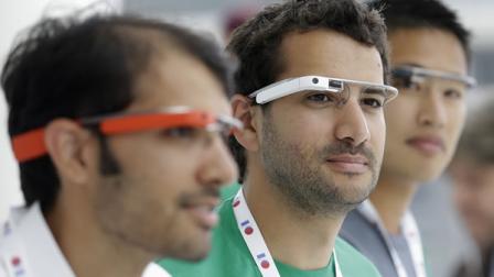 Google Glass team members wear Google Glasses at a booth at Google I/O 2013 in San Francisco.