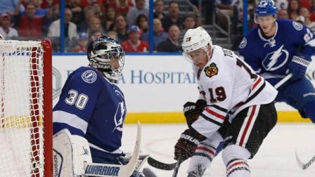 Tampa Bay Lightning goalie Ben Bishop (30) blocks a shot from Chicago Blackhawks center Jonathan Toews (19) during the third period of an NHL hockey game on Thursday, Oct. 24, 2013, in Tampa, Fla. The Lightning won 6-5.