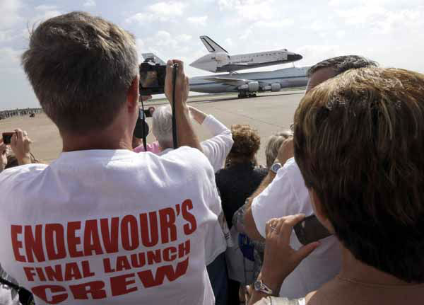 The space shuttle Endeavour is shown taxiing...