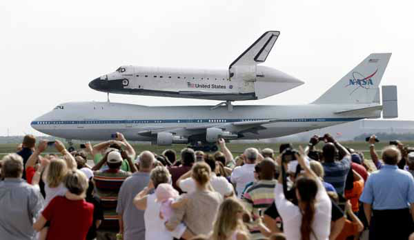 The space shuttle Endeavour is shown taxiing...