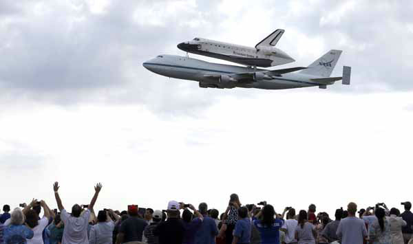 The space shuttle Endeavour is shown taxiing...
