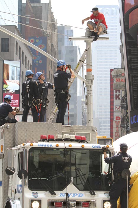 New York City police officers negotiate with an...