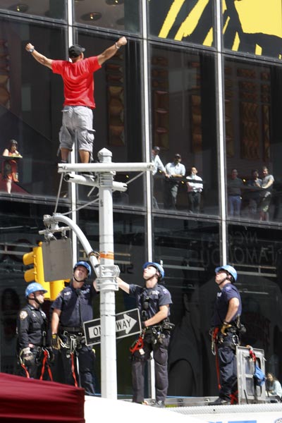 New York City police officers watch while an...