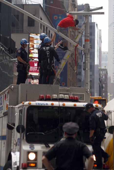 New York City police officers  watch as an...