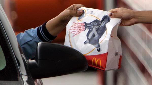 An employee hands a drive-thru order to a McDonalds customer at the Rock and Roll McDonalds in Chicago, Oct. 15, 2007.