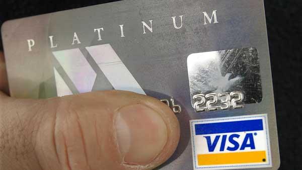 FILE--The Visa logo on a card holders credit card is shown in Springfield, Ill., Monday, Feb. 25, 2008. (AP Photo/Seth Perlman)