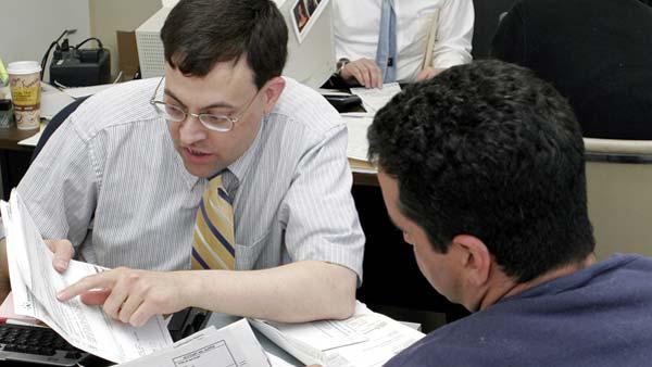 A tax preparer for Holtzman Tax Services prepares a last minute tax return for a client.