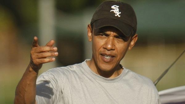 FILE: Then-President-elect Barack Obama, wearing a Chicago White Sox baseball cap, gestures to onlookers after working out at the Semper Fit Center at Marine Corp Base Hawaii in Kailua, Hawaii, Monday, Dec. 29, 2008. (AP Photo/Gerald Herbert)
