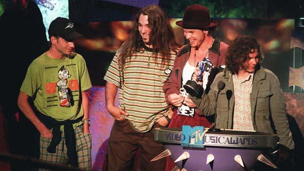 FILE--Members of the grunge group Pearl Jam celebrate their MTV award for best group video, one of four awards the band won, for their video teen suicide lament, Jeremy, at the MTV Video Music Awards in 1993. They are, left to right, Stone Gossard, Dave Abrunnsee, Jeff Ament, and lead singer Eddie Vedder. (AP Photo/ Kvork Djansezian)