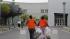 Jail female inmates pick up trash cans outside...