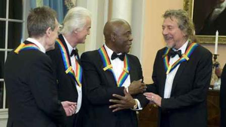 2012 Kennedy Center Honorees and members of Led Zeppelin John Paul Jones, left, Jimmy Page, second from left, and Robert Plant, right, talk with fellow 2012 Kennedy Center Honoree Buddy Guy at the end of the State Department Dinner for the Kennedy Center Honors gala Saturday, Dec. 1, 2012 at the State Department in Washington.