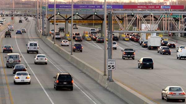 FILE: Motorists using manual and automatic lanes, which also accept I-PASS, slow as they approach a toll plaza on I-355 Thursday, Dec. 16, 2004, in Downers Grove, Ill., while other drivers with transponders use unobstructed I-PASS lanes on the left. (AP Photo/M. Spencer Green)