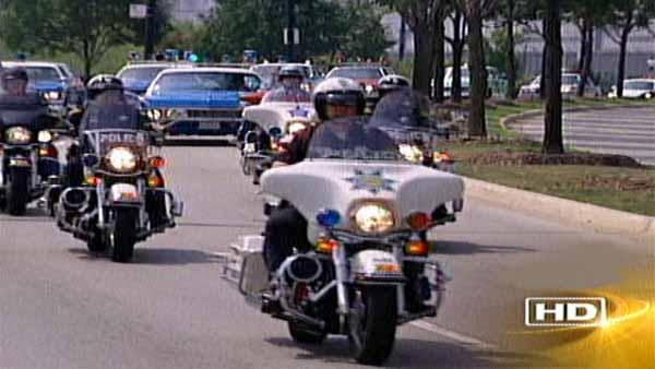 The riders formed a procession more than two miles long consisting of officers on motorcycles, followed by vintage squad cars from various police departments.
