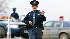 A Michigan State Police officer guards a road block on Tomer Street after a FBI of raid of a suspected militia leader's home in Clayton, Mich., Sunday, March 28, 2010. The FBI said Sunday that agents conducted weekend raids in Michigan, Indiana and Ohio and arrested at least three people.