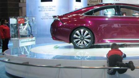 A toddler climbs on the display of the 2013 Toyota NS4 Hybrid Concept at the 2012 Chicago Auto Show, located at McCormick Place in Chicago on Monday, Feb. 13, 2012.