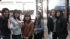 Friends huddle together while waiting hours to...