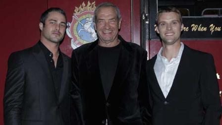 This image released by NBC shows, from left, Taylor Kinney, Executive Producer Dick Wolf, and Jesse Spencer at the world premiere of the new NBC series Chicago Fire at the Chicago History Museum in Chicago on Tuesday, Oct. 2, 2012. Guests included more than 350 firefighters from the Chicago Fire Department representing multiple generations.
