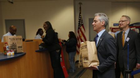 Mayor Rahm Emanuel makes his personal donation to the 2013 Stamp Out Hunger food drive at the James R. Thompson Center in Chicago, Ill. on May 10, 2013. The National Association of Letter Carriers food drive, supported by Campbell Soup Company, will take place this Saturday, May 11, and benefits Feeding America member food banks.