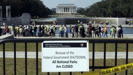 Despite signs stating that the national parks are closed, people visit the World War II Memorial in Washington, Wednesday, Oct. 2, 2013. Most of the visitors were WWII veterans who came to Washington on an honor flight to visit the memorial. It was an act of civil disobedience that marked the fact some barriers nor a government shutdown would keep a group of World War II veterans from visiting the monument erected in their honor. The Lincoln Memorial is in the background. 