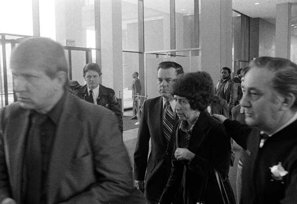 Mrs. Harry Piest is assisted by a deputy, right,...