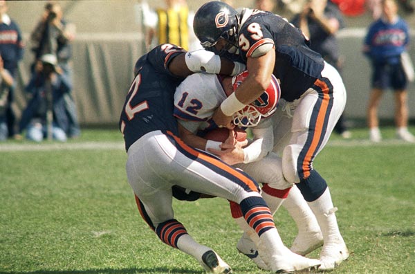 Buffalo Bills quarterback Jim Kelly is sacked by...
