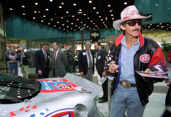 Richard Petty signs autographs during a press...