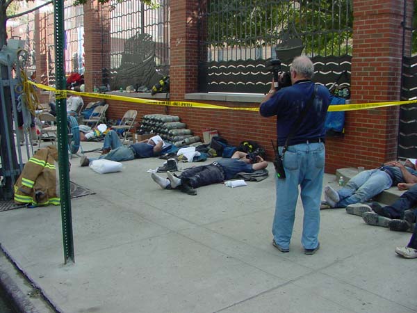 Firemen sleeping on the sidewalk