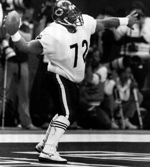 Chicago Bears William Perry spikes the ball...
