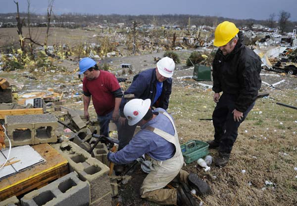 Emergency medical personnel search the...