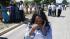 A woman reacts with others as they await word on...