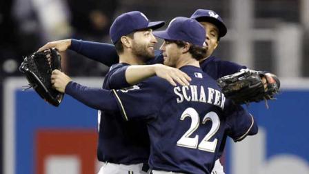 Milwaukee Brewers left fielder Ryan Braun, left, Brewers right fielder Logan Schafer (22) and Brewers center fielder Carlos Gomez (27) hug in the outfield after defeating the San Diego Padres 7-1 during a baseball game Monday, April 22, 2013, in San Diego.