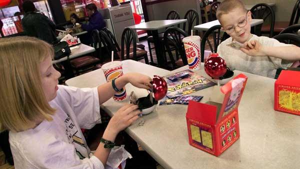 Children look over Pokemon toys received as giveaways at a Burger King restaurant in Hackensack, N.J., Tuesday, Dec. 21, 1999. (AP Photo/Jeff Zelevansky)