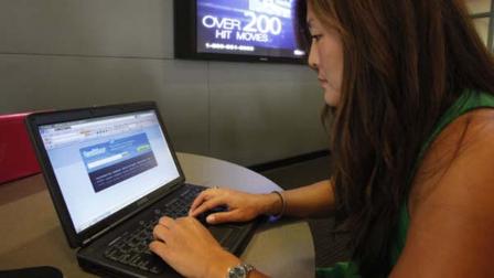 In this Aug. 6, 2009 file photo, college student Joy Troy checks a twitter page at the Annenberg School of Communication department at the University of Southern California campus in Los Angeles. (AP Photo/Damian Dovarganes, File)