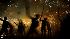 Revelers hold torches as they take part in...