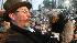 Punxsutawney Phil, right, is held by Ben Hughes...
