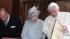 Britains Queen Elizabeth II, centre, exchanges...