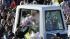 Pope Benedict XVI greets the crowd from his...
