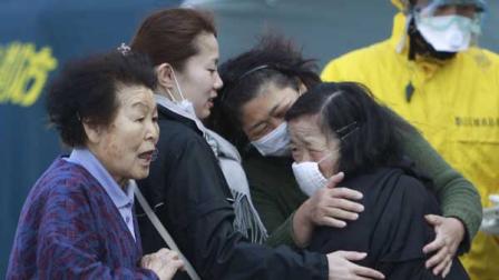 Residents evacuated from areas surrounding the Fukushima nuclear facilities damaged in Fridays massive earthquake react during a check for radiation contamination, Sunday, March 13, 2011, in Koriyama city, Fukushima prefecture, Japan.
